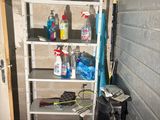 a shelf that has various cleaning supplies on it