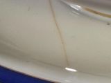 a close up of a white plate with blue trim