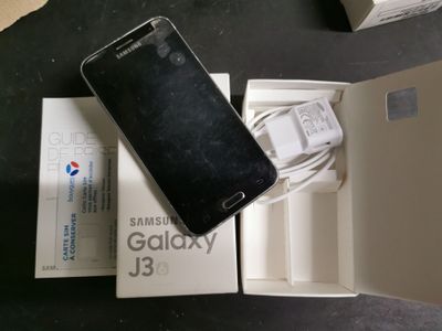 a box with a phone inside of it on a table
