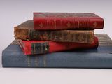three books stacked on top of each other on a table