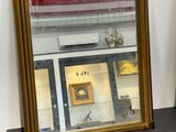 two mirrors on a shelf in front of a window