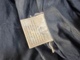 a label on the back of a jacket that has a tag attached to it