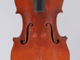 an old violin with a bow hanging from it ' s back