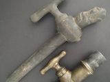 two old brass faucets that are on a table