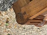 a close up view of a wooden bench with a marble top