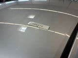 a sign on the hood of a car that is parked in a garage