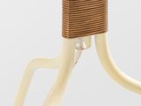 a close up of a white table with a rattan top and metal legs