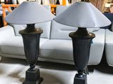 two lamps that are sitting on a table in a room