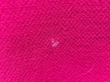 pink fabric with a white spot on it