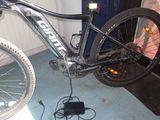 a bike that is sitting on the floor with a charger