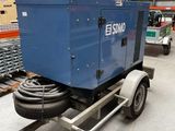 an image of a trailer with a blue machine on it in a warehouse