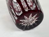 a red glass vase with a star design on it