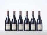 six bottles of red wine lined up in a row