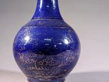 a blue vase sitting on a table with a white background