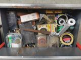 a metal box filled with assorted items and scissors