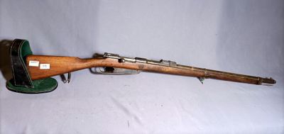 an old rifle with a wooden barrel on a white background