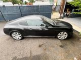 a picture of a black sports car parked in a parking lot