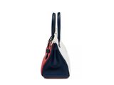a blue and white handbag with a red handle