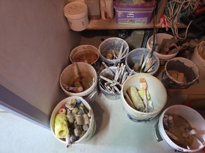 many buckets of food that are sitting on the floor