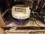 a machine that is sitting on a shelf in a room
