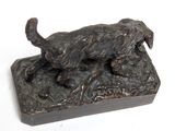 a statue of a dog that is standing on a block