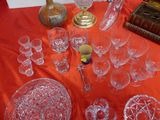 a red table cloth with a lot of glassware on it