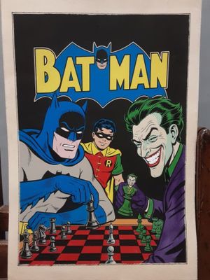 the batman chess game is displayed on a wooden table