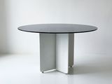 an image of a white table with a black top on a white floor