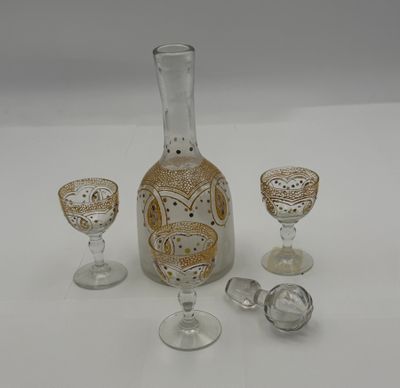 three glasses and a decanter sitting on a table