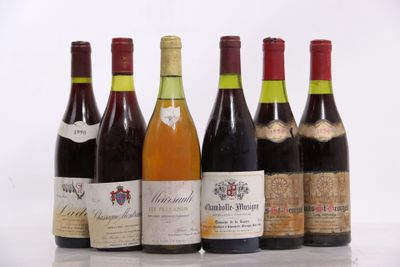 six bottles of wine are lined up in a row on a table