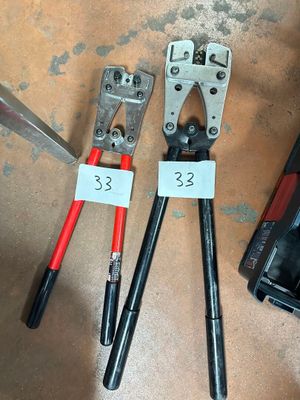 two pliers and a pair of pliers next to a tool box