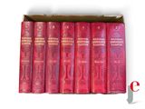 six red books in a cardboard box on a white background