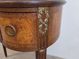 a small wooden table with a mirror on top of it