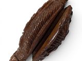 two pieces of chocolate sitting on top of each other on a white surface