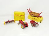 a red toy tractor with a trailer and other toy vehicles