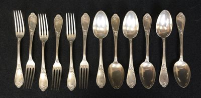 a lot of spoons and forks on the table