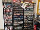 many shelves of beer in a store with a sign on the wall