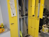a yellow locker in the corner of a room with yellow doors