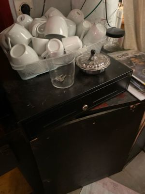 a black table with a bunch of white dishes on it