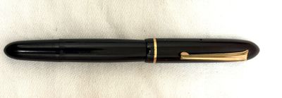 an image of a black pen with gold trim sitting on a white surface