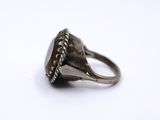 a close up of a silver ring on a white surface