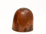 an image of a small wooden object on a white surface