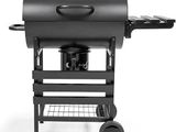 a close up of a grill with a kettle on top of it