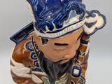 a figurine of a man wearing a hat and holding a baseball bat