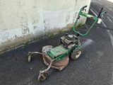 a lawn mower that is sitting on the ground