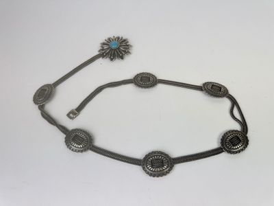 a close up of a necklace on a white surface