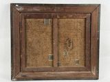 an old wooden frame with a picture of a man and a woman