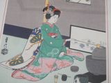 a picture of a woman sitting on the floor reading a book