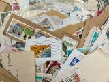 a pile of stamps and envelopes sitting on a table