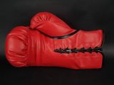 pair of red boxing gloves on a black background